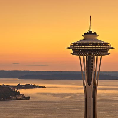Sunset behind the Space Needle, the Puget Sound visible in the background.