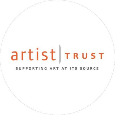 Circular logo with orange text reading "Artist Trust" and black text below reading "Supporting art at its source"