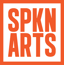 Orange sans serif font reads "SPKN ARTS" surrounded by a bold orange border.