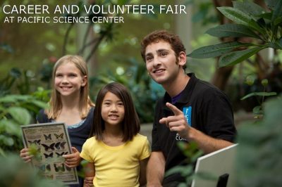 Two youths look at a butterfly exhibit together with a museum worker point to something amidst a background of lush foliage. Text in upper left corner reads "Career & Volunteer Fair at Pacific Science center"