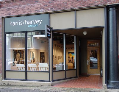 Exterior of a storefront art gallery, a sign reading "Harris/Harvey Gallery" above the front window