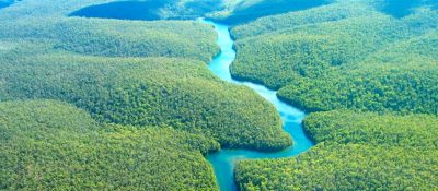 Aerial view of a river winding through the Amazon rainforest
