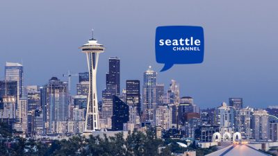 Seattle city skyline, featuring the Space Needle. White text in a blue speech bubble in the center reads "Seattle Channel"