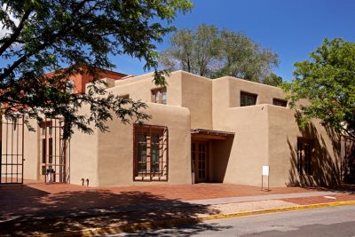 Exterior of an adobe museum entrance.