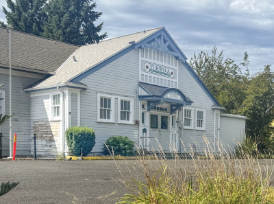 White wood paneled building with a sign that reads "Tukwila Historical Society"