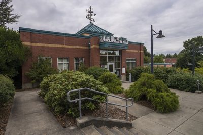 red brick community park building with stairs in front