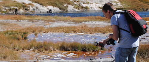 UW AB student Michael Diamond checks the water's temperature in Yellowstone UW AB student Michael Diamond checks the water's temperature in Yellowstone
