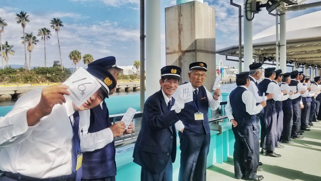 Men in uniforms greeting passengers