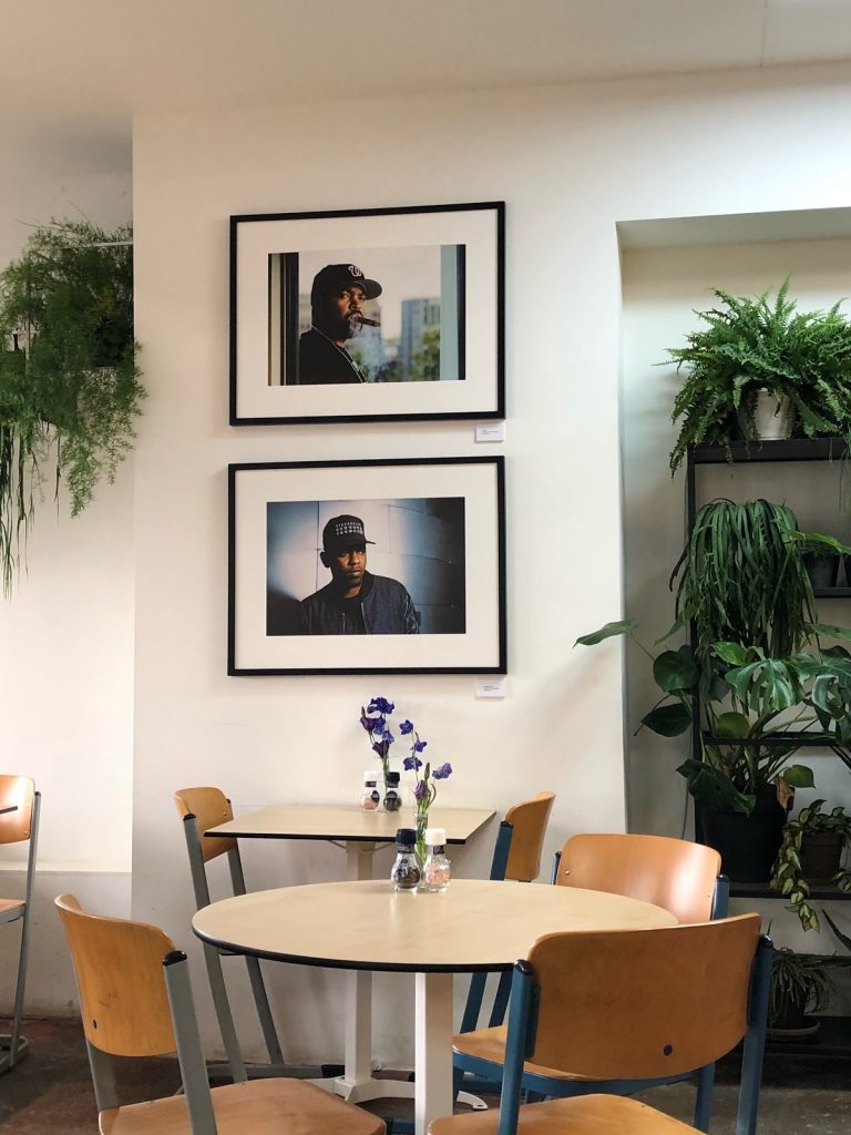 Portraits of rappers on wall of cafe