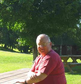 Bill's picture: sitting at a picnic table at camp