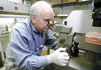 Seymour Klebanoff at microscope