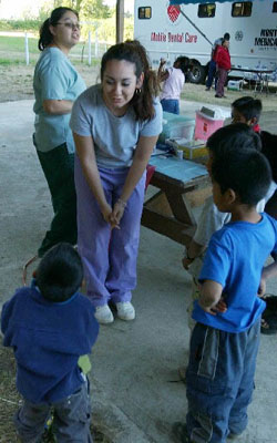 a medical student talking to toddler patients