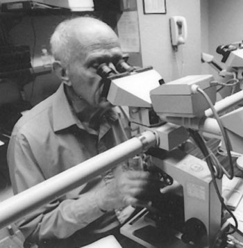 doctor Cyrus Rubin looking through a microscope
