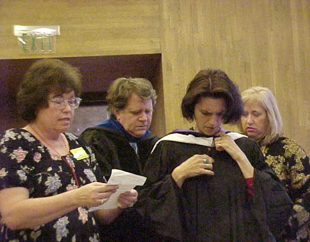 Faculty don academic regalia.