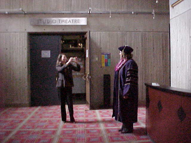 Taking picture of graduate before ceremony