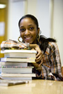 female student leaning on books