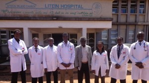 Medical students stand with Dismas Ongore, senior lecturer at the University of Nairobi School of Public Health, in Litein, a Kenya town. 