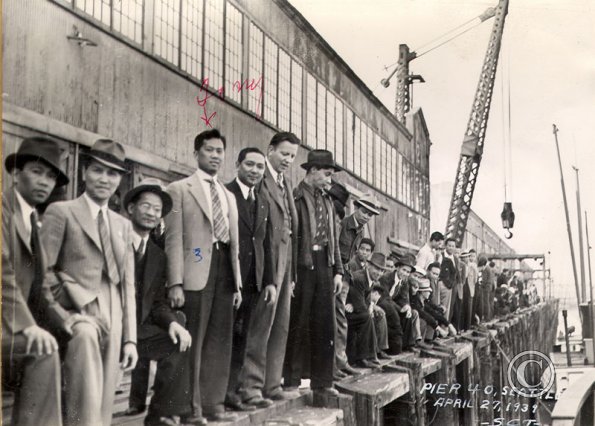 Men wait on pier 40 to board the ship that will take them to Alaska. April 27, 1939