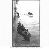 Survivors from wreck of schooner JOSEPH RUSS boarding steamer DORA_ off Chirikof Island_ April 1912 
