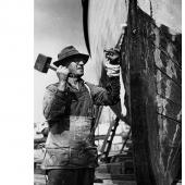 Workman repairing hull of boat_ Seattle_ Washington_ ca_ 1940 