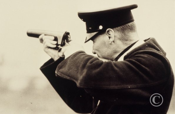 19 - Policeman Trying Out The New Tear Gas Bullet Gun