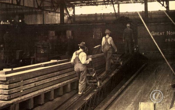 pushing cargo on the "iron stevedore," treadmill. Seattle 1927