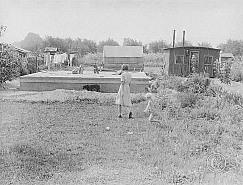 Constructing housing on half acre in Yakima shacktown.