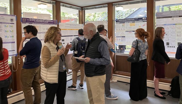 A group of people look at research posters