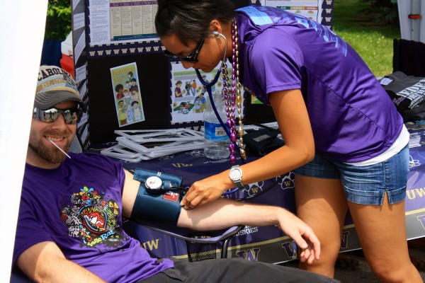 MEDEX performed blood pressure checks during the race to address health awareness for both children and adults. Student Krystal Agtarap is shown checking Chris Williams blood pressure before the event.