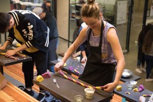 Culinary Nutrition Sciences 241 students roll pasta in Husky purple and gold, University of Washington Nutritional Sciences Program