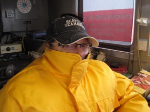 Researcher bundled up in foul weather gear