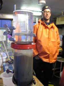 Researcher next to core sample