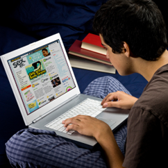 Here is an over-the-shoulder-view of a teen boy who is sitting on the floor and looking at the website Sex, Etc. on his laptop computer.