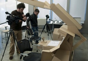 Nate Landes, left, and Sergei Larionov prepare to photograph the flight deck mock-up they are working on with Axel Roesler; photo by Dan Ostrowski