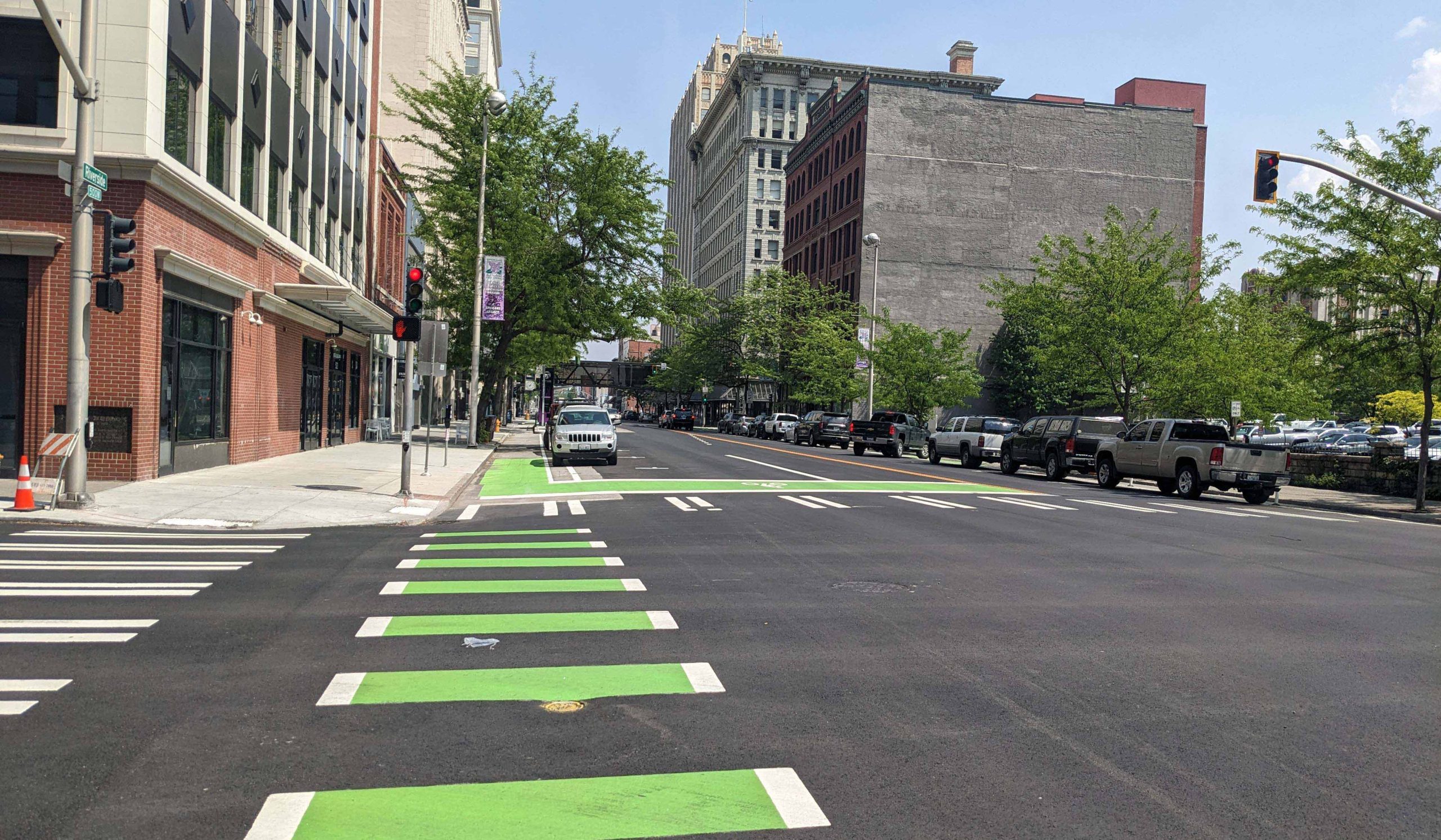 New green bicycle crossing markings and bike lane in an intersection in downtown Spokane, Washington.