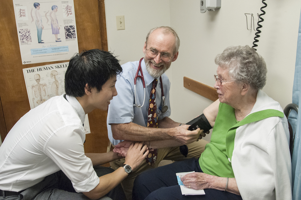 Dr. Greg Rice, WWAMI instructor, family medicine, advising third-year medical student during physical exam of geriatric patient at the Libby Clinic in Libby, Montana.