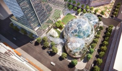 Aerial view of a large glass geodesic dome, filled with plants.
