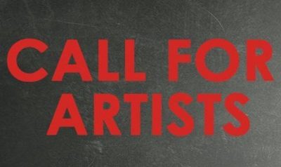 Red text against a blackboard reads "Call for Artists." To the right of the frame, someone holds up a red paper megaphone.