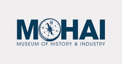 Navy blue sans serif text reads "MOHAI; Museum of History & Industry" on a light grey background. The "O" in "MOHAI" is a compass.