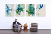 Person sits in a lounge chair in front of four abstract painting panels
