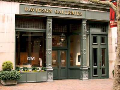 Gallery storefront with green trim and green columns, viewed from outside. Gold text sign above the door reads "Davidson Galleries"