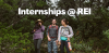 three individuals in hiking gear stand together in the woods. text over the image reads "Internships @ REI"