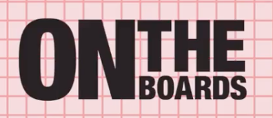 Pink and red grid background, with black text reading "On the Boards"