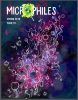 Textured painted dark blue, purple, and grey background with white line drawing of cell structure over it. White text in top left corner reads "Microphiles". The "O" is a magnifying glass showing more cells. Text below that reads "Spring 2019; Issue 01."