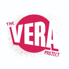 Pink and white text reads "The Vera Project." The word "Vera" is in white, set against a pink circle.