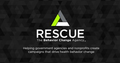Tessellated triangle background in vary shades of gray, with a brighter single, central triangle in green, grey, and white. White central text reads, "Rescue; The Behavior Change Agency". Text below that reads, "Helping government agencies and nonprofits create campaigns that drive health behavior change."