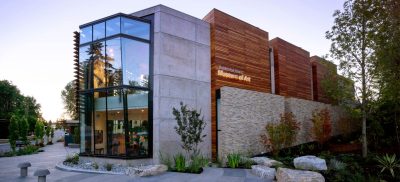Exterior of a modern concrete and wood paneled art museum building.