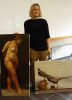 Artist stands holding two oil painted canvases, one depicting a nude figure and one depicting two birds.
