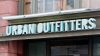Turquoise dimensional lettering above a storefront entrance reads "Urban Outfitters"
