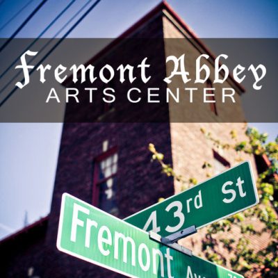 Green cross street sign reading "43rd St" and "Fremont" in front of a red bricked building with a multi story church town. Text over image reads "Fremont Abbey Arts Center"